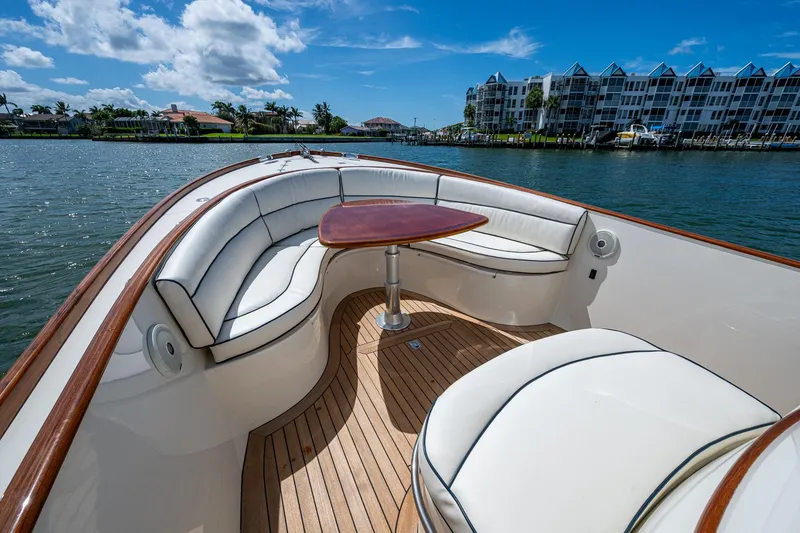 Slide: The Image of Luxurious 2003 Hinckley Talaria 29 Center Console boat with elegant seating and wooden deck. - 8