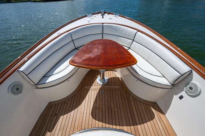 Slide: The Image of 2003 Hinckley Talaria 29 Center Console with elegant seating and wooden table on deck. - 9