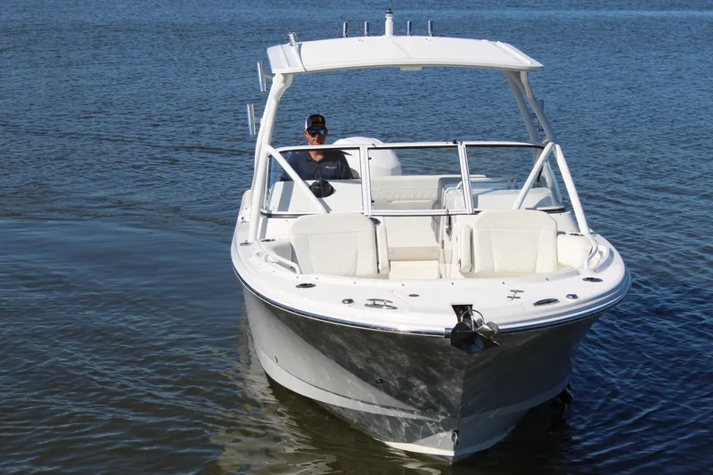 Slide: The Image of 2020 Edgewater 248CX Crossover boat on calm water, front view. - 1