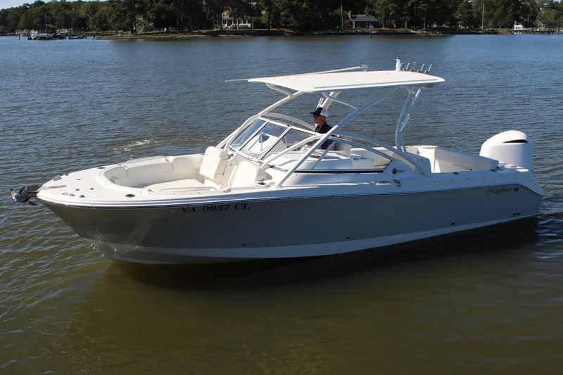 Slide: The Image of 2020 Edgewater 248CX Crossover boat cruising on a calm lake. - 10