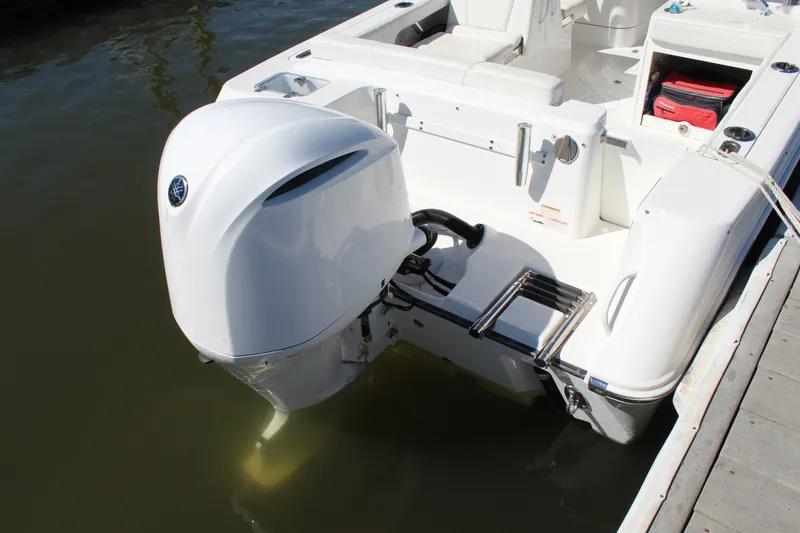 Slide: The Image of Edgewater 248CX Crossover 2020 boat with outboard motor at dock. - 11