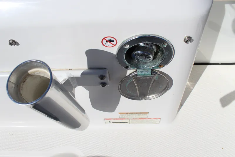 Slide: The Image of Edgewater 248CX Crossover 2020 boat fuel cap and rod holder detail. - 18