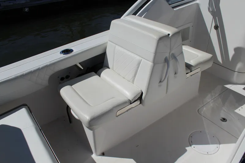 Slide: The Image of White seating on 2020 Edgewater 248CX Crossover boat, featuring sleek design and comfortable upholstery. - 20