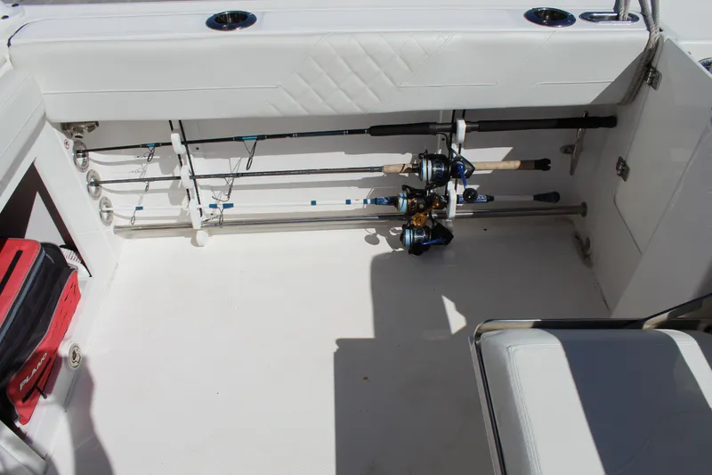 Slide: The Image of Interior of 2020 Edgewater 248CX Crossover boat with fishing rod storage. - 21