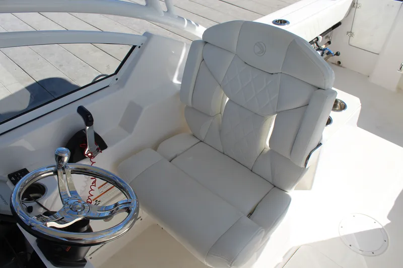 Slide: The Image of Luxurious helm seat and steering wheel of 2020 Edgewater 248CX Crossover boat. - 23