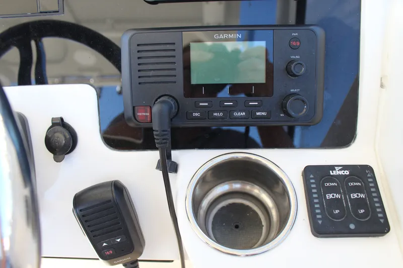 Slide: The Image of Control panel of 2020 Edgewater 248CX Crossover with Garmin radio and Lenco trim tab switches. - 26