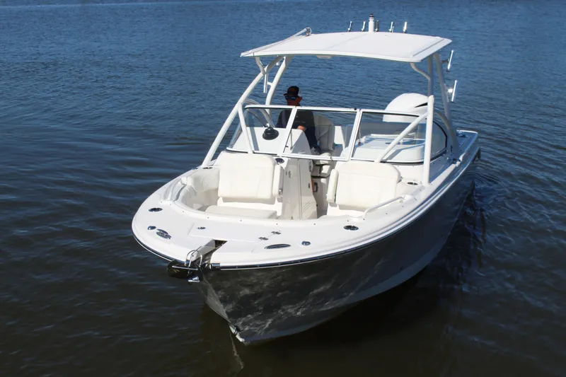 Slide: The Image of 2020 Edgewater 248CX Crossover boat on calm water, featuring sleek design and spacious seating. - 3