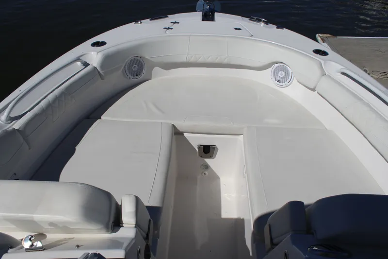Slide: The Image of 2020 Edgewater 248CX Crossover boat interior with white seating and speakers. - 30
