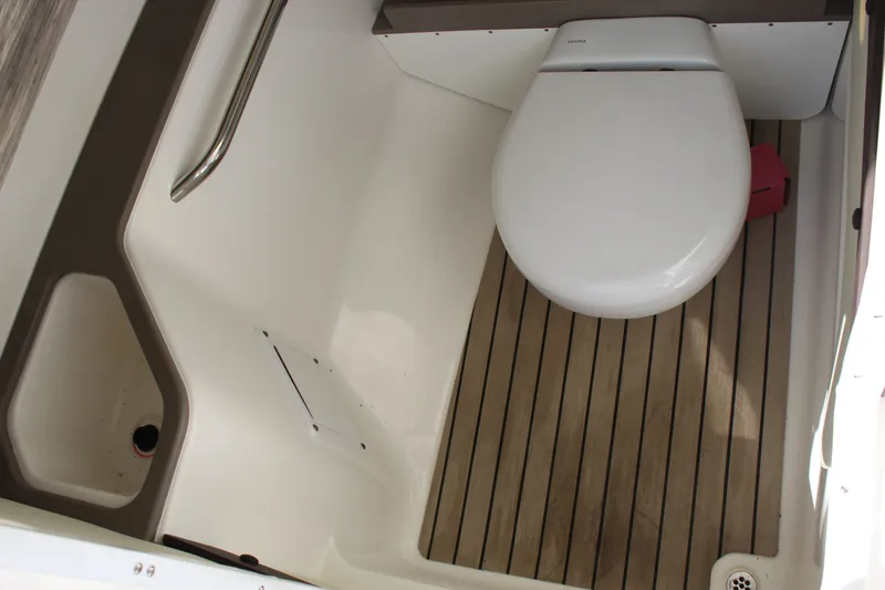Slide: The Image of 2020 Edgewater 248CX Crossover boat bathroom with wooden flooring and modern toilet. - 35