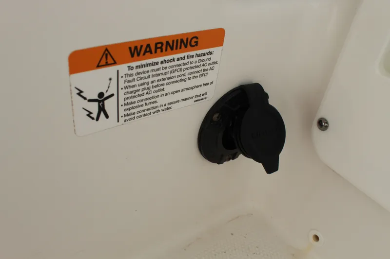 Slide: The Image of Warning label and outlet on 2020 Edgewater 248CX Crossover boat. - 36