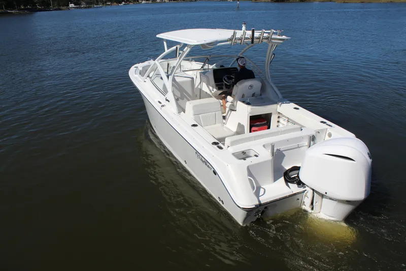 Slide: The Image of 2020 Edgewater 248CX Crossover boat cruising on calm water. - 4