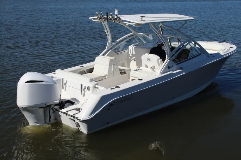 Slide: The Image of 2020 Edgewater 248CX Crossover boat on calm water, featuring sleek design and outboard motor. - 6