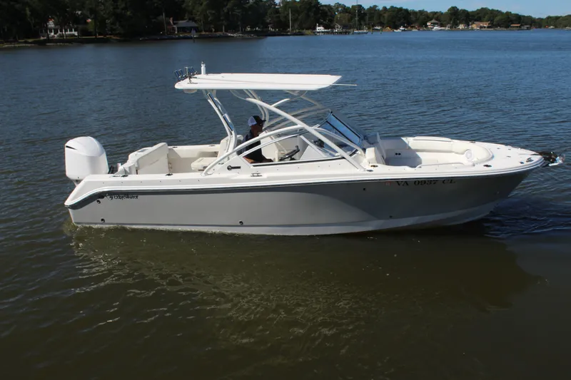 Slide: The Image of 2020 Edgewater 248CX Crossover boat cruising on a calm lake. - 7