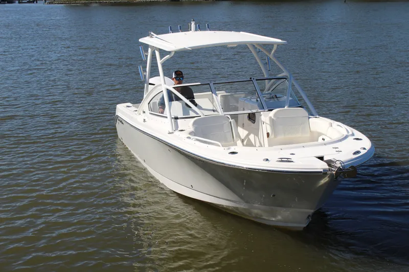 Slide: The Image of 2020 Edgewater 248CX Crossover boat cruising on calm water. - 8