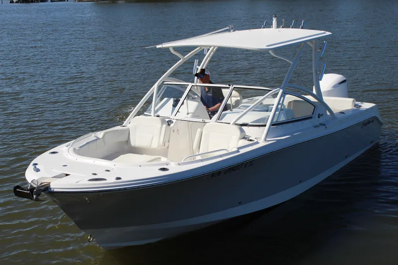 Slide: The Image of 2020 Edgewater 248CX Crossover boat on calm water, featuring sleek design and spacious seating. - 9