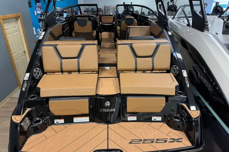 Slide: The Image of 2026 Yamaha Boats 255XD interior with tan seating and sleek design. - 4