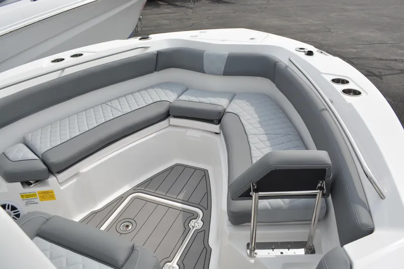 Slide: The Image of Luxurious seating area on 2026 NauticStar 242 Offshore boat, featuring gray cushioned seats. - 12