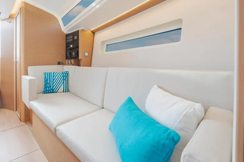 Slide: The Image of Interior of 2026 Jeanneau Sun Odyssey 350 yacht with modern seating and cushions. - 12