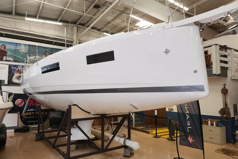 Slide: The Image of 2026 Jeanneau Sun Odyssey 350 sailboat displayed indoors on a stand. - 27