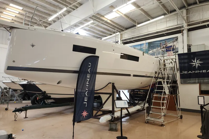 Slide: The Image of 2026 Jeanneau Sun Odyssey 350 sailboat in indoor showroom with Jeanneau branding. - 30