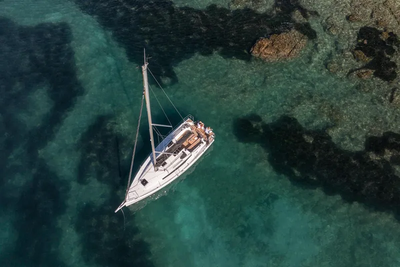 Slide: The Image of Aerial view of 2026 Jeanneau Sun Odyssey 350 sailing in clear turquoise waters. - 8