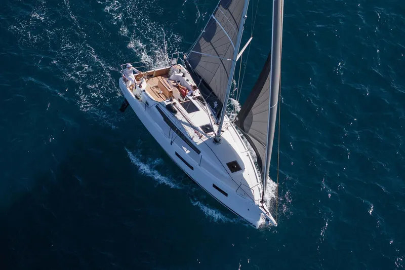 Slide: The Image of 2026 Jeanneau Sun Odyssey 350 sailing on open blue sea, aerial view. - 9