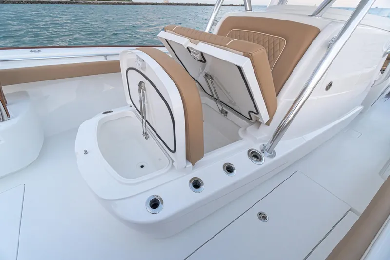 Slide: The Image of 2026 Valhalla Boatworks V-37 interior with open storage compartments and seating. - 10