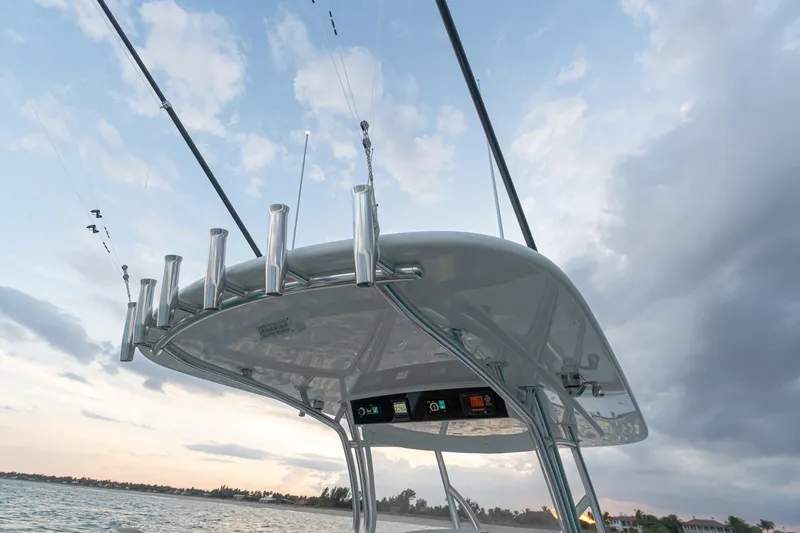 Slide: The Image of 2026 Valhalla Boatworks V-37 fishing rods and canopy against a scenic sky. - 14