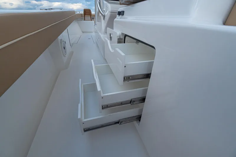 Slide: The Image of 2026 Valhalla Boatworks V-37 interior with open storage drawers, showcasing sleek design. - 17
