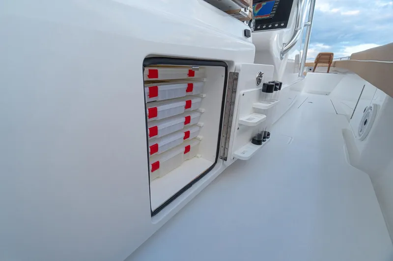 Slide: The Image of 2026 Valhalla Boatworks V-37 interior storage compartment with organized tackle boxes. - 18
