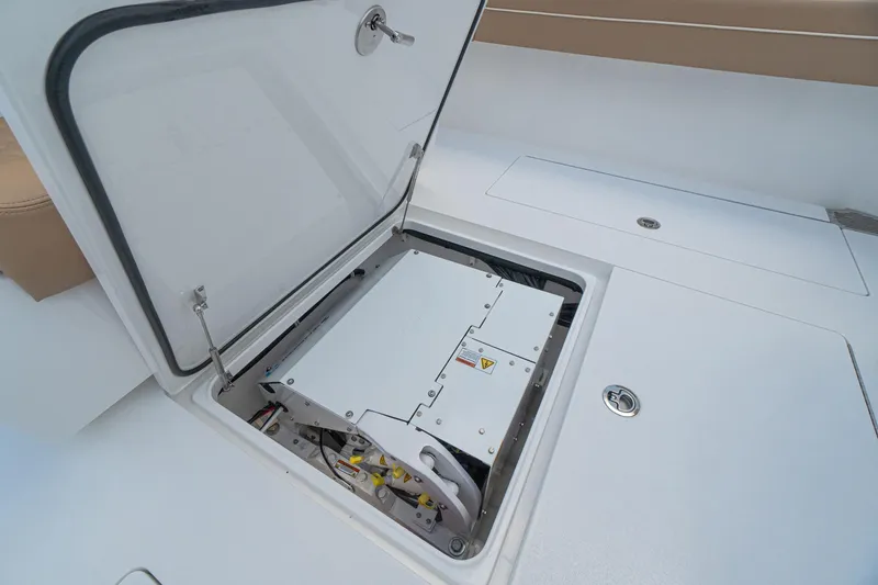 Slide: The Image of 2026 Valhalla Boatworks V-37 storage compartment with open hatch, showcasing interior equipment. - 24