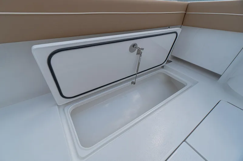 Slide: The Image of 2026 Valhalla Boatworks V-37 storage compartment with open hatch and cushioned seating. - 25