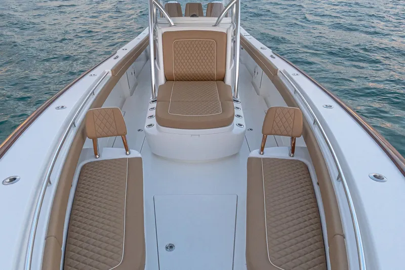 Slide: The Image of 2026 Valhalla Boatworks V-37 interior with tan seating on calm water. - 6