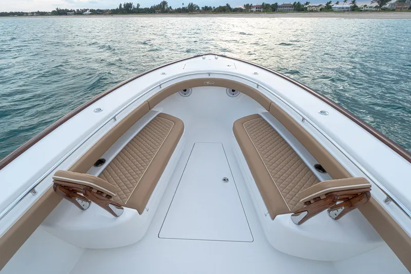 Slide: The Image of 2026 Valhalla Boatworks V-37 bow with tan seating, on calm water. - 8