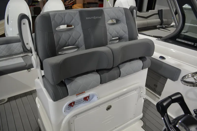 Slide: The Image of 2026 NauticStar 252 Legacy boat interior with gray cushioned seating and modern design. - 12