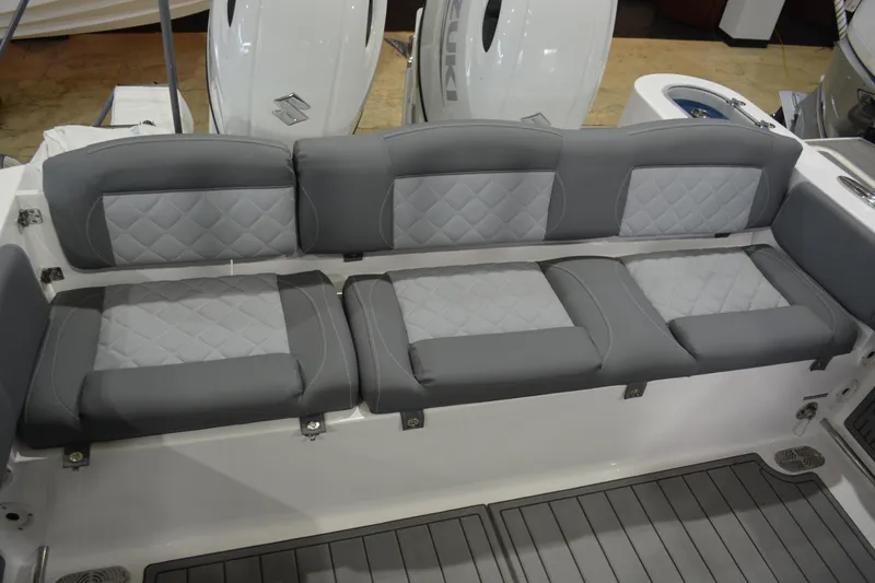 Slide: The Image of 2026 NauticStar 252 Legacy boat with gray cushioned seating and modern design. - 17