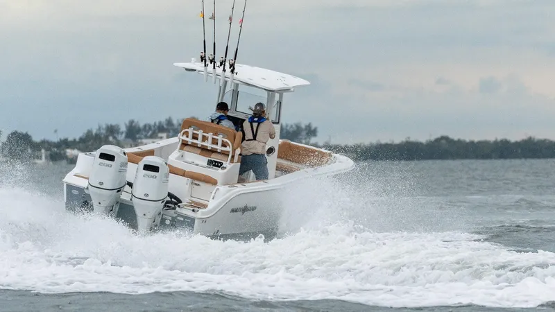 Slide: The Image of 2026 NauticStar 252 Legacy boat displayed indoors on wooden blocks. - 3