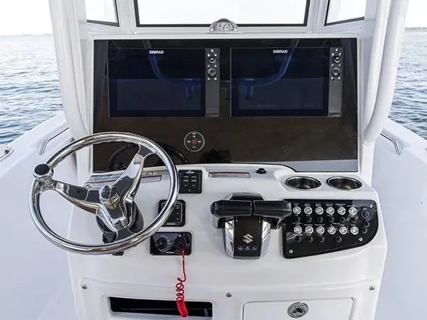 Slide: The Image of 2026 NauticStar 252 Legacy boat with dual engines in a showroom. - 6