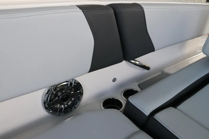 Slide: The Image of 2026 Chaparral 250 OSX boat interior with speaker and cup holders. - 11