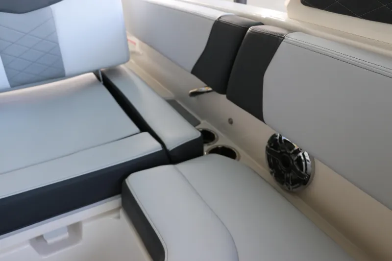 Slide: The Image of Interior seating of 2026 Chaparral 250 OSX boat with speaker and cup holders. - 12