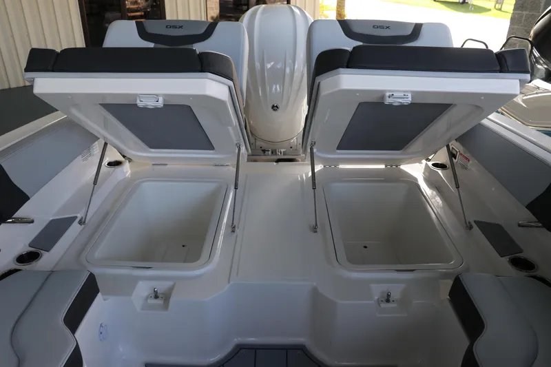 Slide: The Image of 2026 Chaparral 250 OSX boat with open storage compartments and seating. - 13