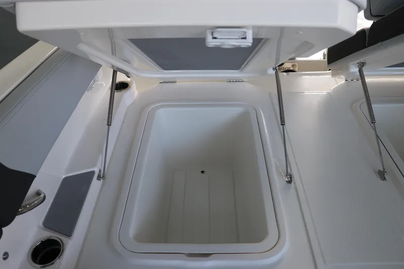 Slide: The Image of Open storage compartment on 2026 Chaparral 250 OSX boat, showcasing spacious interior design. - 14