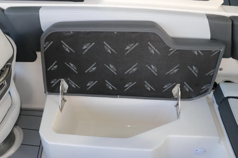 Slide: The Image of 2026 Chaparral 250 OSX boat storage compartment with branded interior lining. - 18