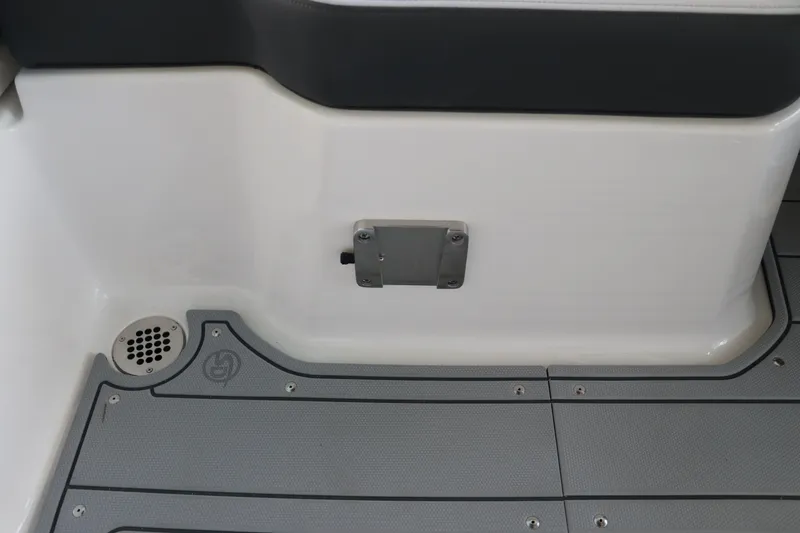 Slide: The Image of Interior detail of 2026 Chaparral 250 OSX boat, featuring sleek flooring and drainage. - 21