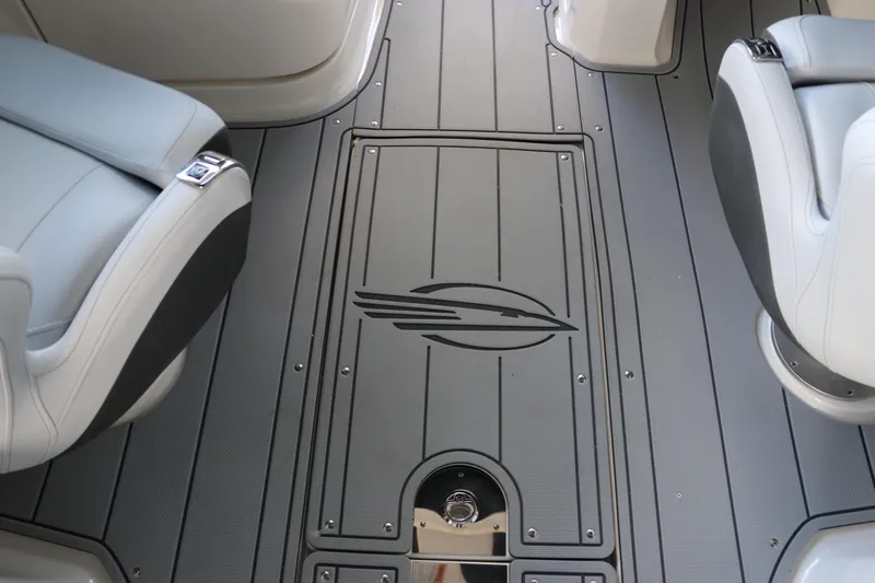 Slide: The Image of 2026 Chaparral 250 OSX boat interior with sleek gray flooring and modern seating. - 25