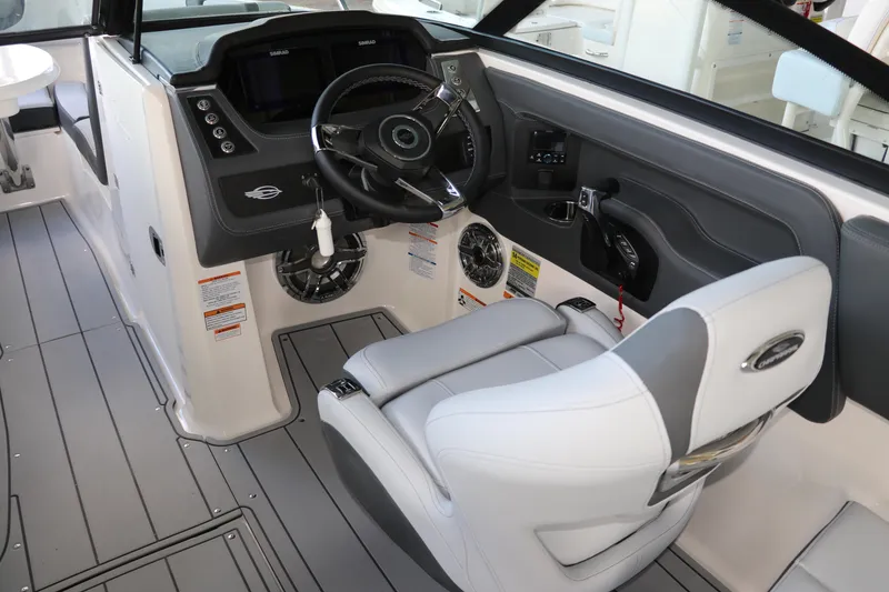 Slide: The Image of 2026 Chaparral 250 OSX boat interior with modern helm and comfortable seating. - 27