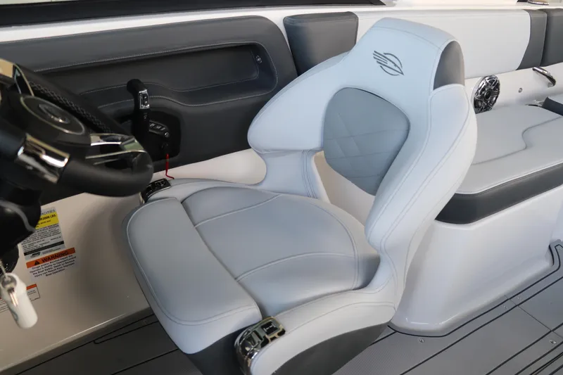 Slide: The Image of 2026 Chaparral 250 OSX boat interior with sleek steering and comfortable seating. - 28