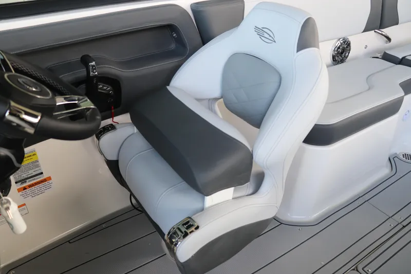 Slide: The Image of 2026 Chaparral 250 OSX boat interior with sleek captain's chair and modern steering wheel. - 29