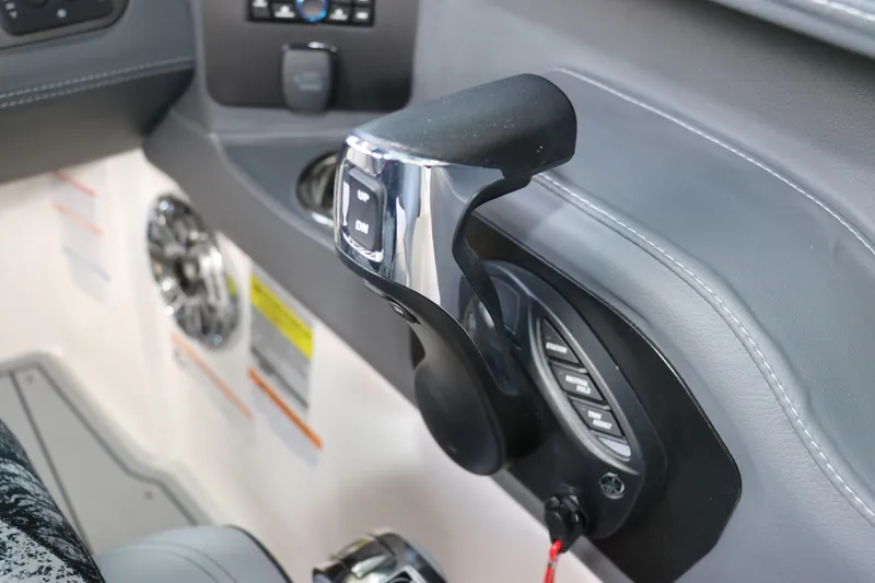 Slide: The Image of Close-up of 2026 Chaparral 250 OSX boat throttle control and dashboard features. - 32