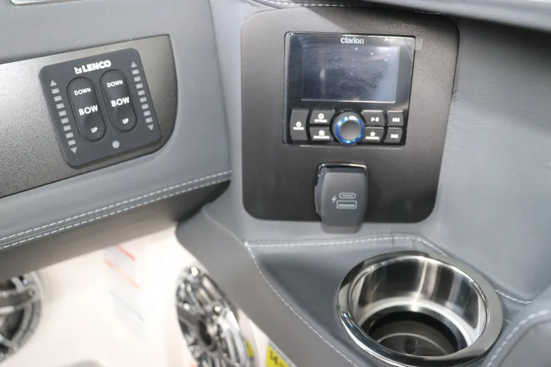 Slide: The Image of 2026 Chaparral 250 OSX boat dashboard with controls, Clarion audio system, and cup holder. - 34